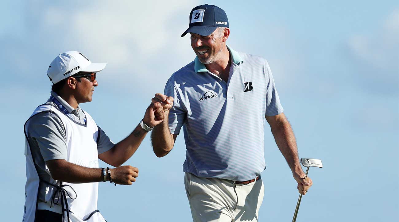 David Giral Ortiz, known as "El Tucan," and Matt Kuchar fist pump during the Mayakoba Golf Classic.