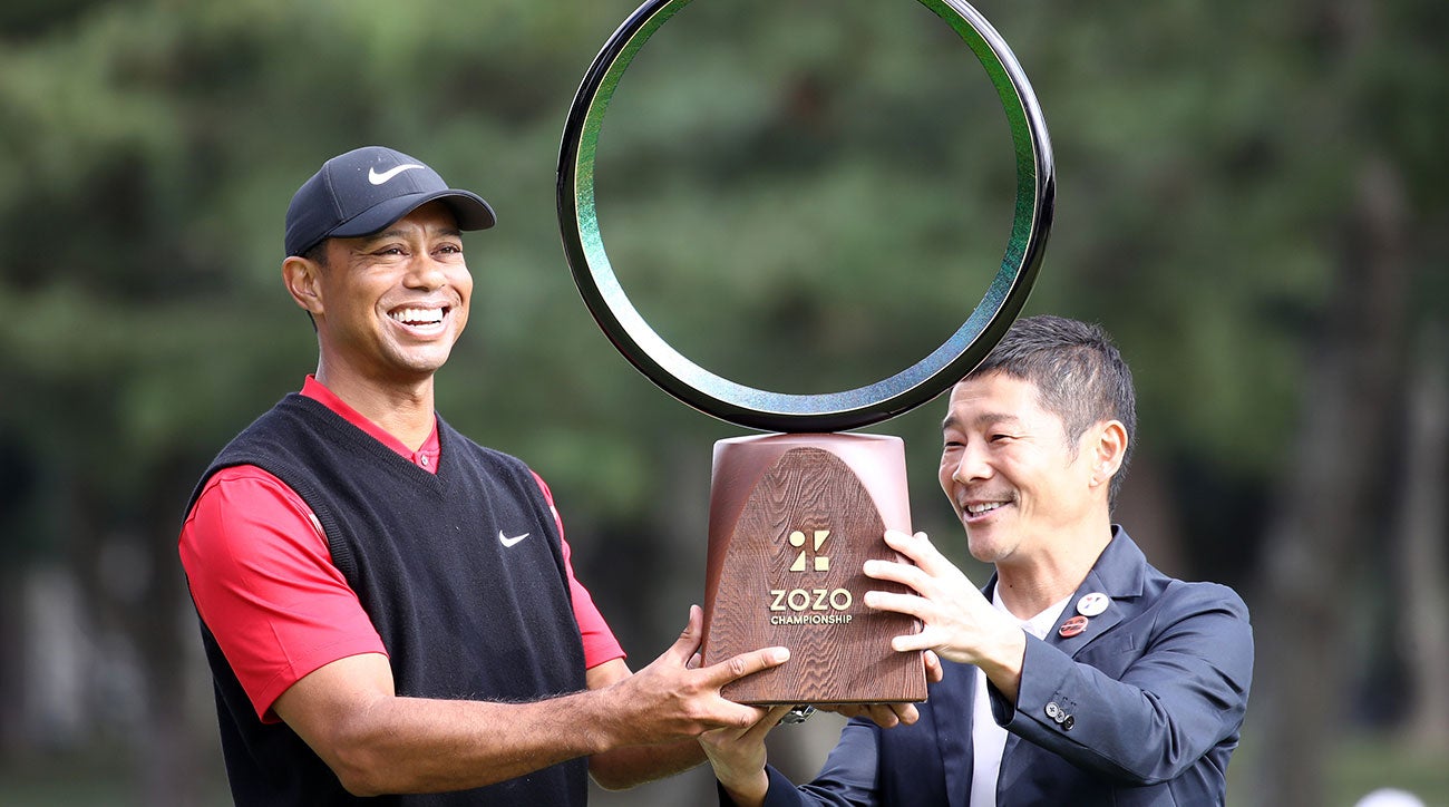 Tiger Woods finally accepts the Zozo Championship trophy after a lengthy ceremony.