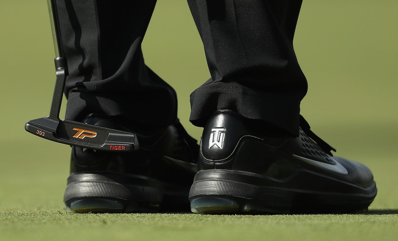 Tiger Woods lines up a putt at the Dell Technologies Championship at TPC Boston.