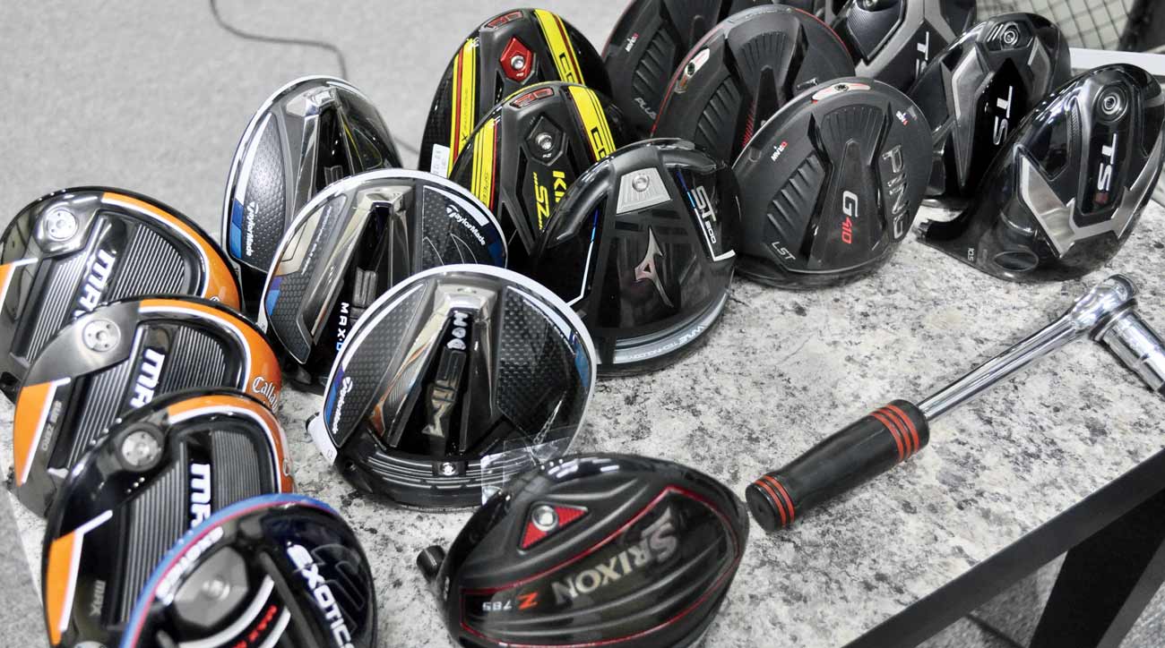 New driver heads from various brands await the robot.