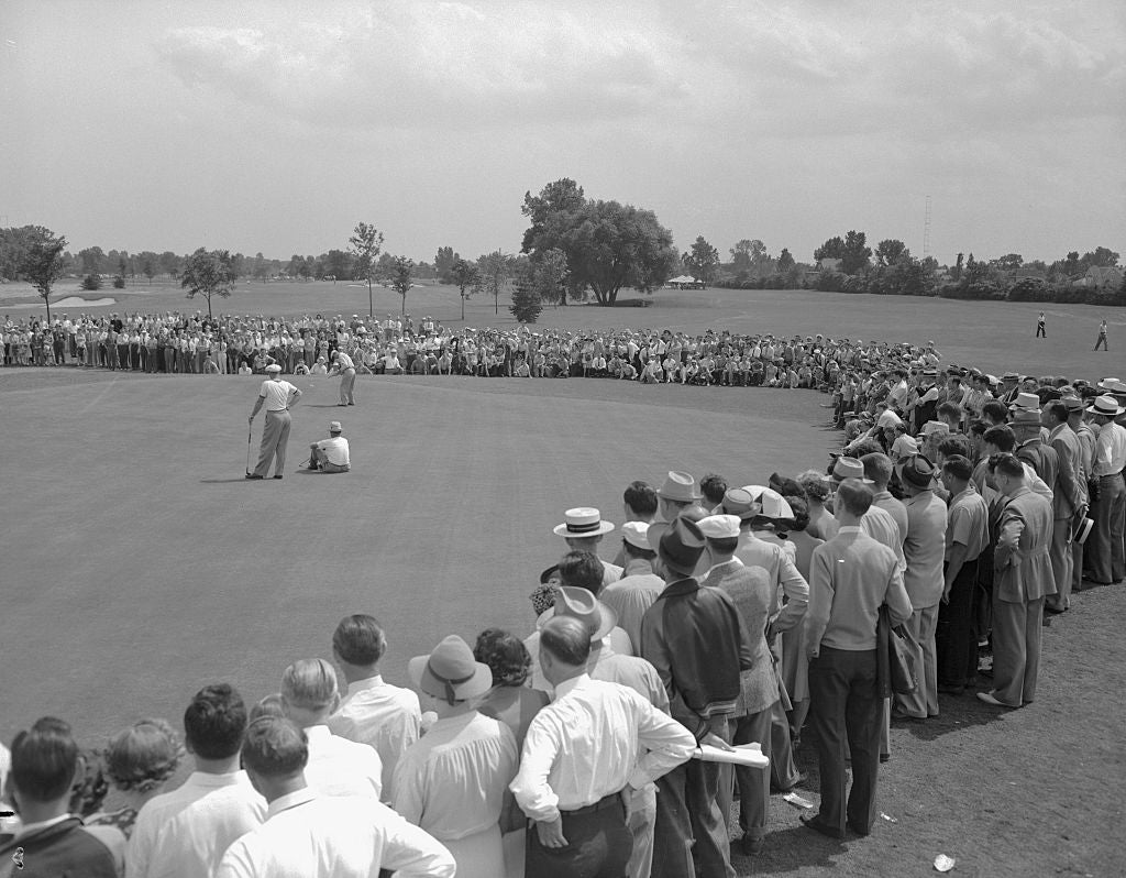 Crowd watches Ben Hogan sink a put during the final round of the Hale America Open at the Ridgemoor Country Club. Hogan, Golf's top money winner for the past three years, took the $1,000 winner's purse with 271 score for 72 holes.
