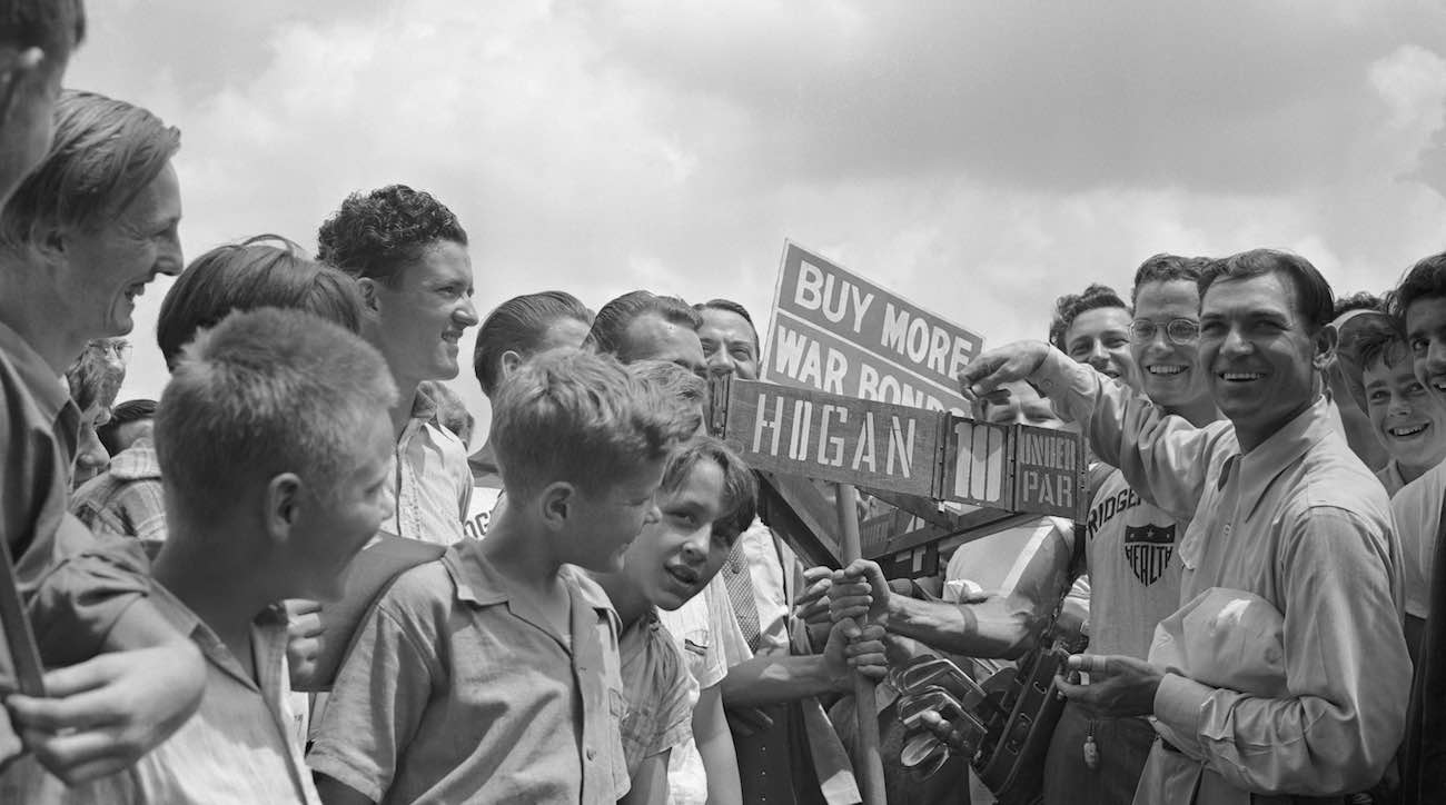 (Original Caption) Ben Hogan of Hershey, Pennsylvania, who fired a 72 in the first round of the Hale America Open at the Ridgemoor Country Club, came back in the second round with a 10-below-par 62 for the lowest 18-hole score ever recorded in the National Golf Competition. Hogan proudly points to his record score as an admiring crowd looks on.