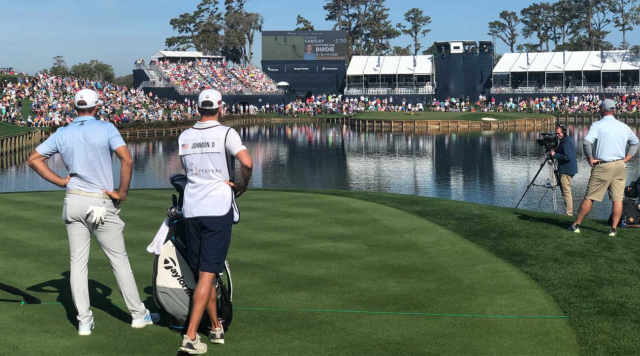 Dustin Johnson prepares to tee off at the famed 17th hole at the Players Championship shortly before the PGA Tour announced its decision to ban fans from entering for the remainder of the week.