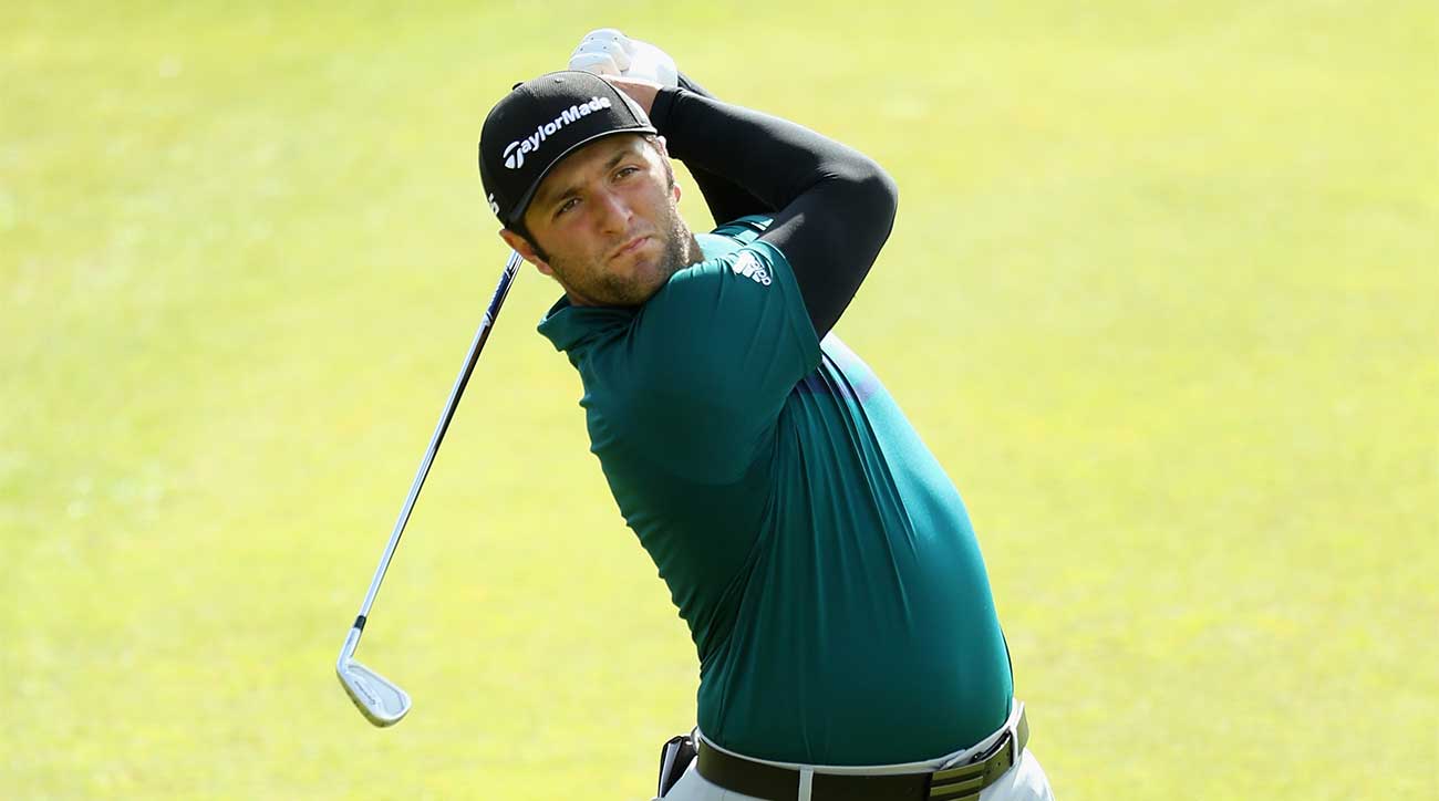 Jon Rahm watches an approach to the green.