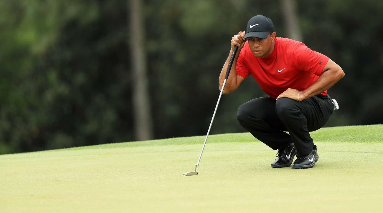 tiger woods studies a putt