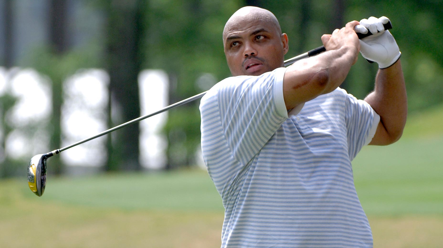 charles barkley swings a golf club
