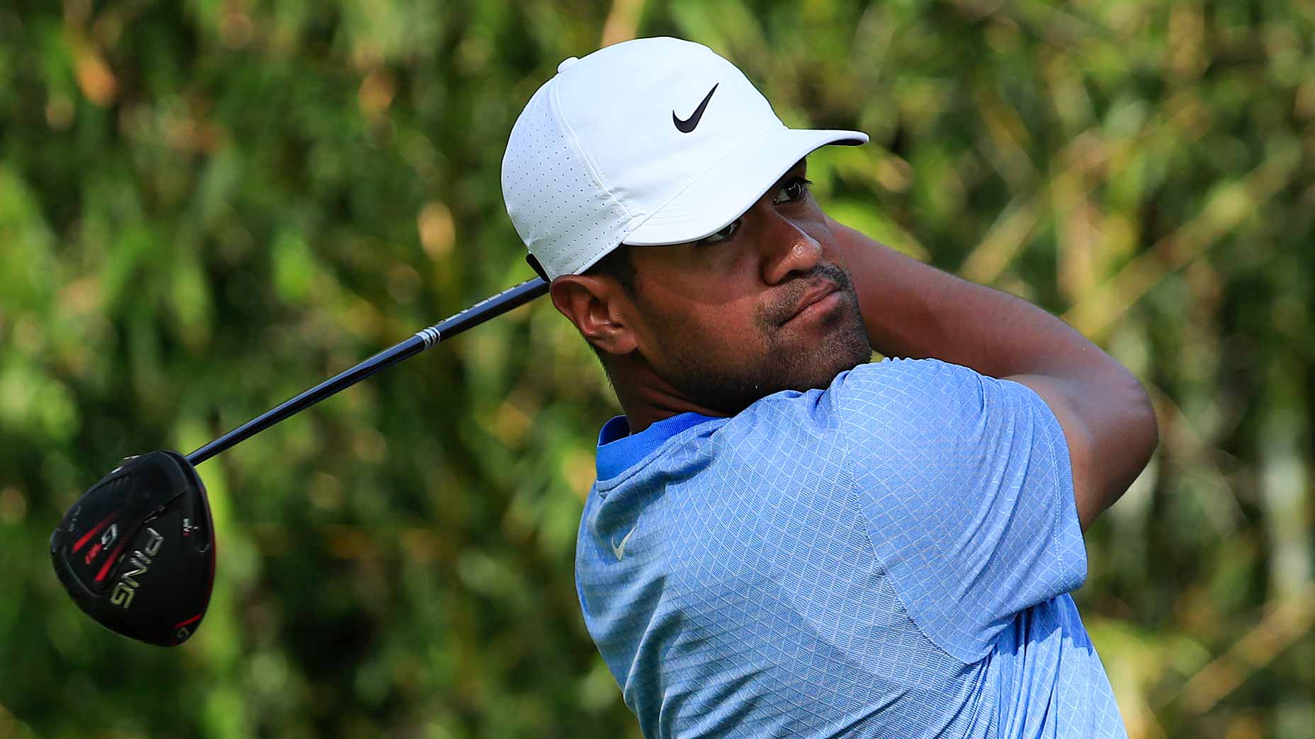 Golfer Tony Finau watches drive