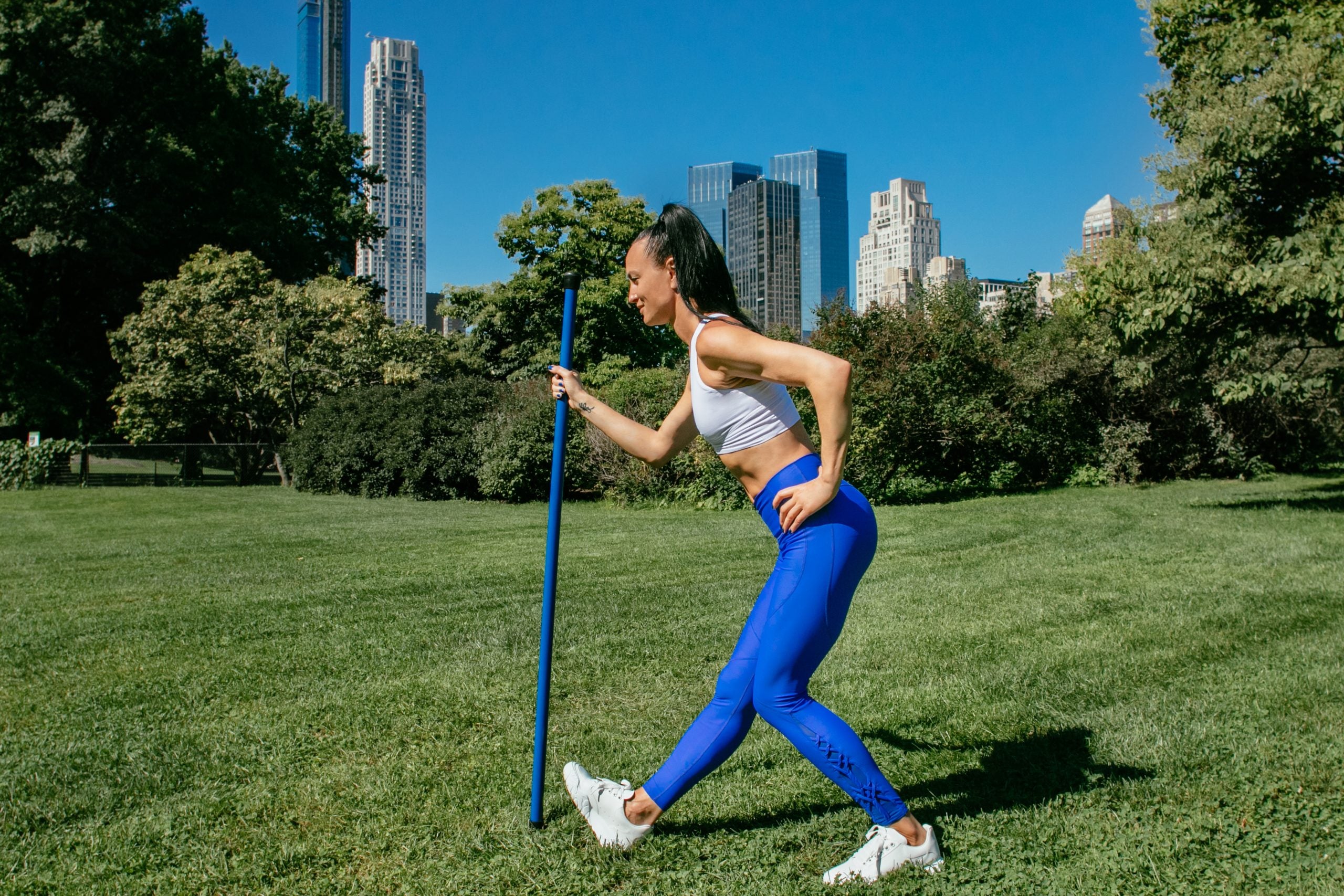 An instructor demonstrates a hamstring stretch.