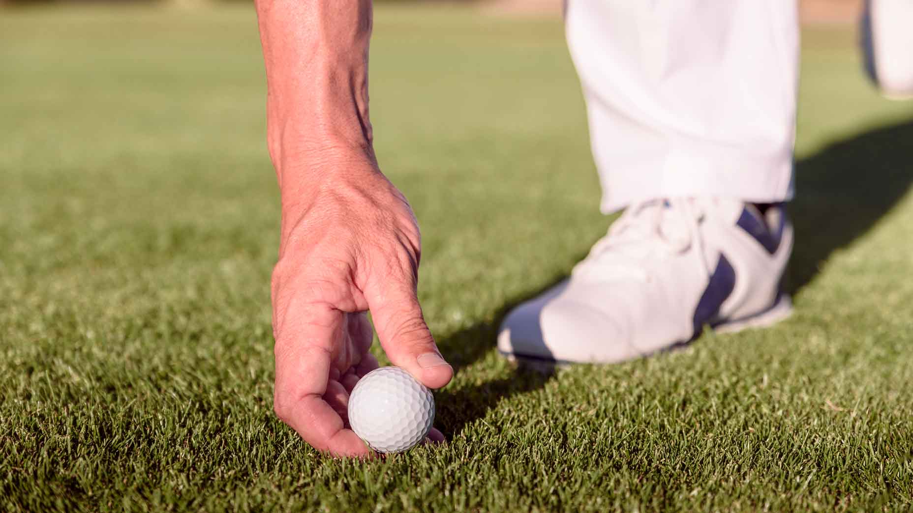 Golfer placing ball