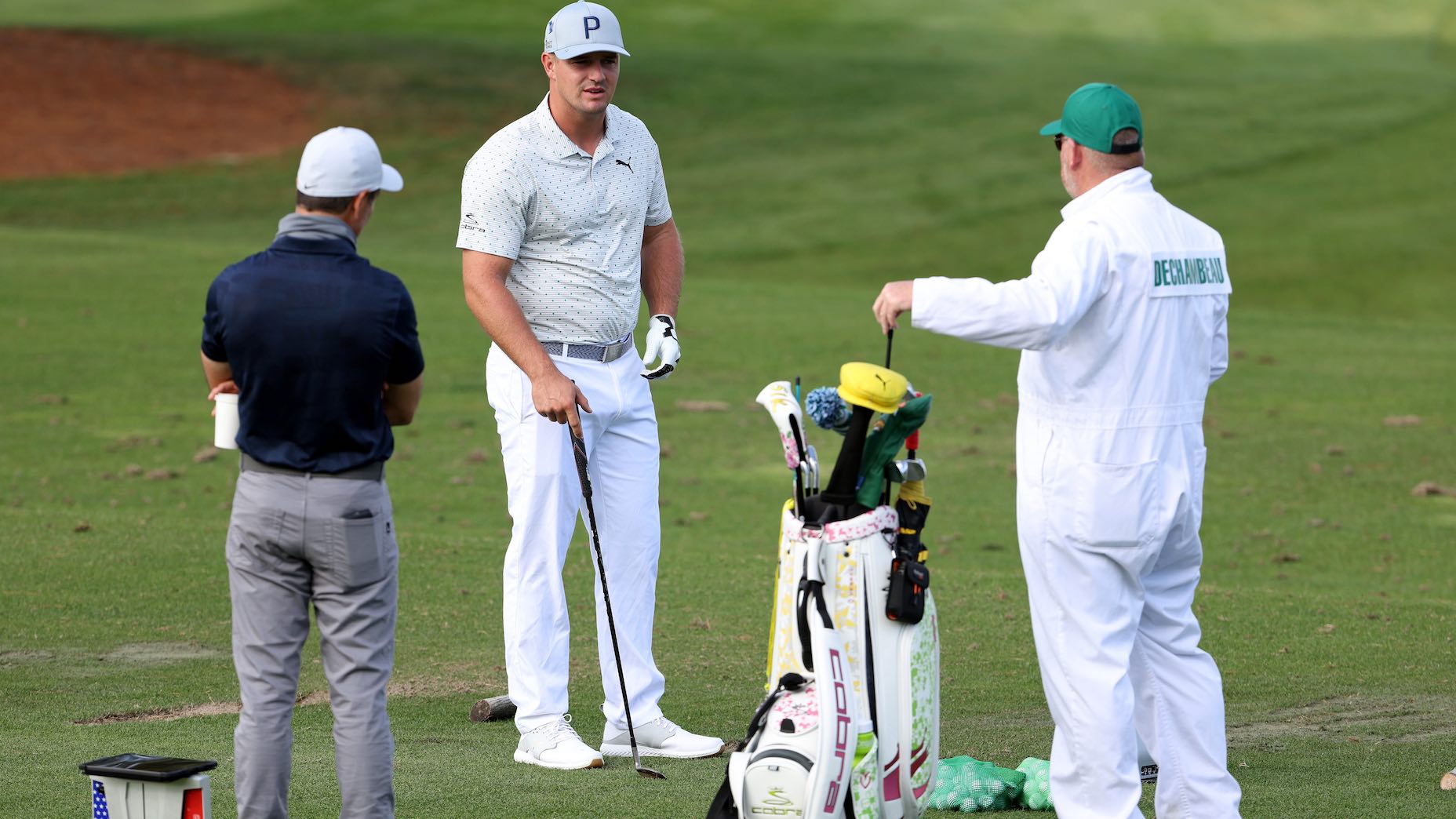 Bryson DeChambeau on the Augusta National range with coach Chris Como behind him.