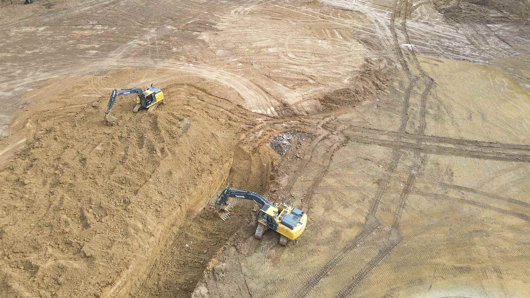 Diggers get to work on bury pits.