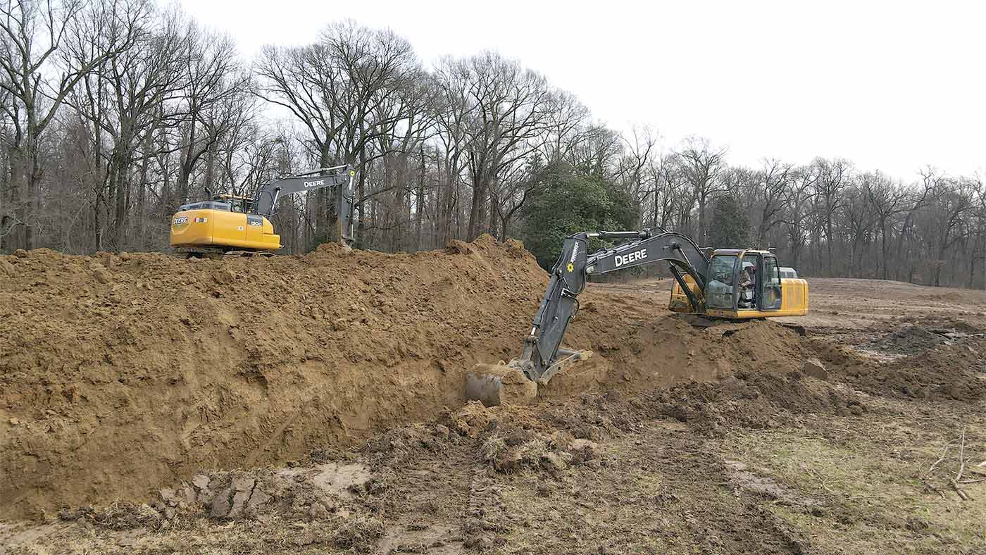 Diggers get to work on bury pits.