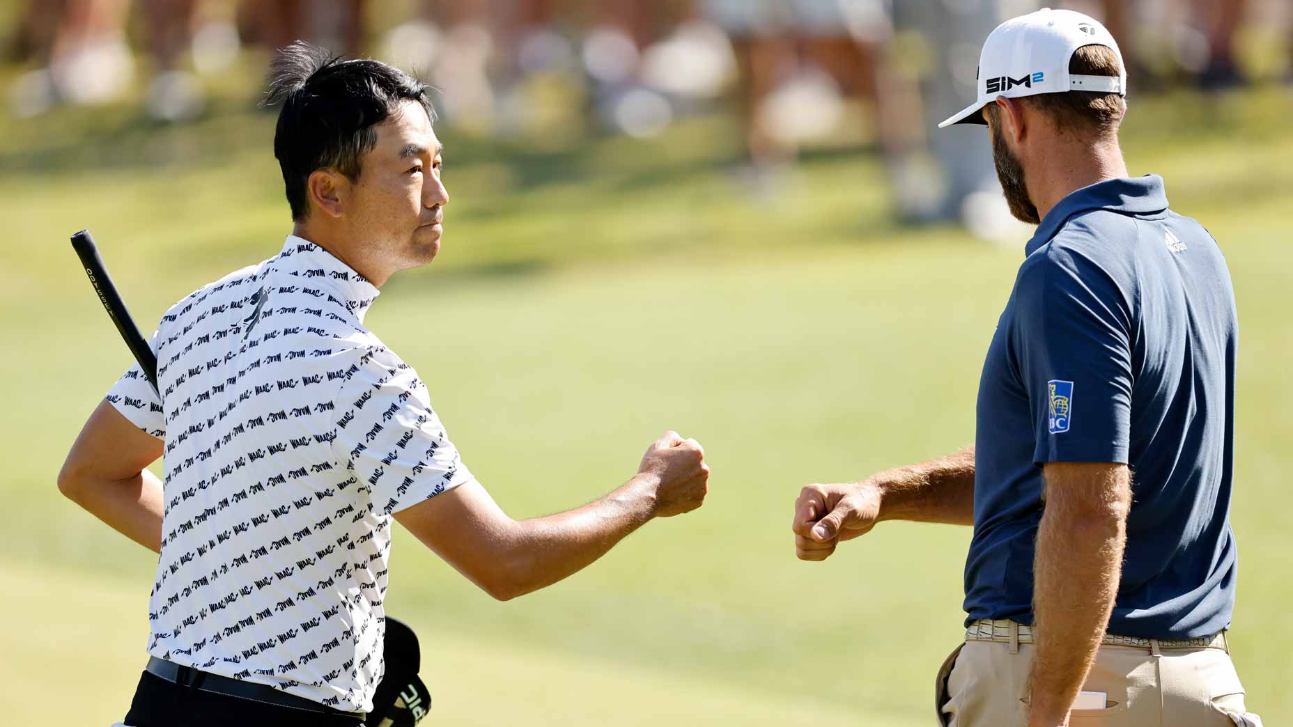 kevin na fist bumps dustin. johnson