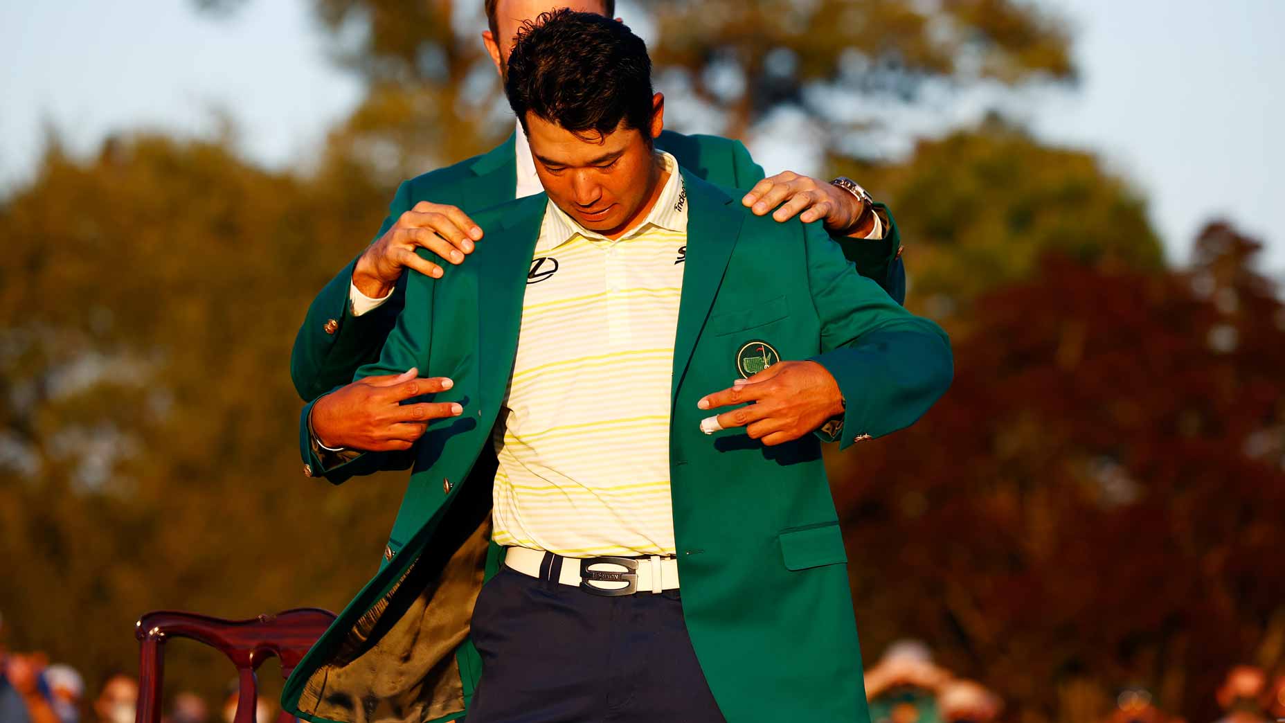 hideki matsuyama slips on the green jacket.