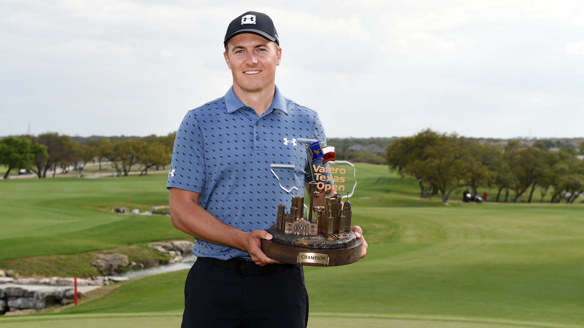 jordan spieth holds trophy
