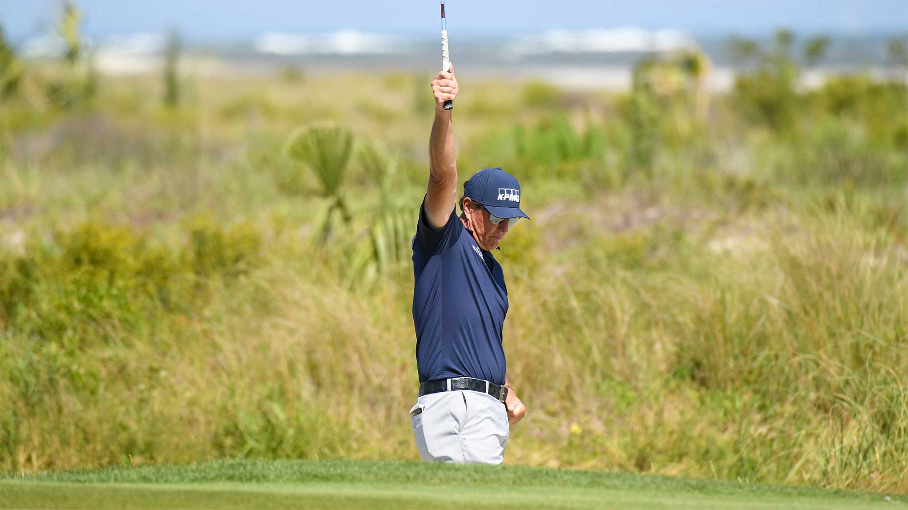 Phil Mickelson celebrates after chipping in for birdie on the par-3 5th hole.
