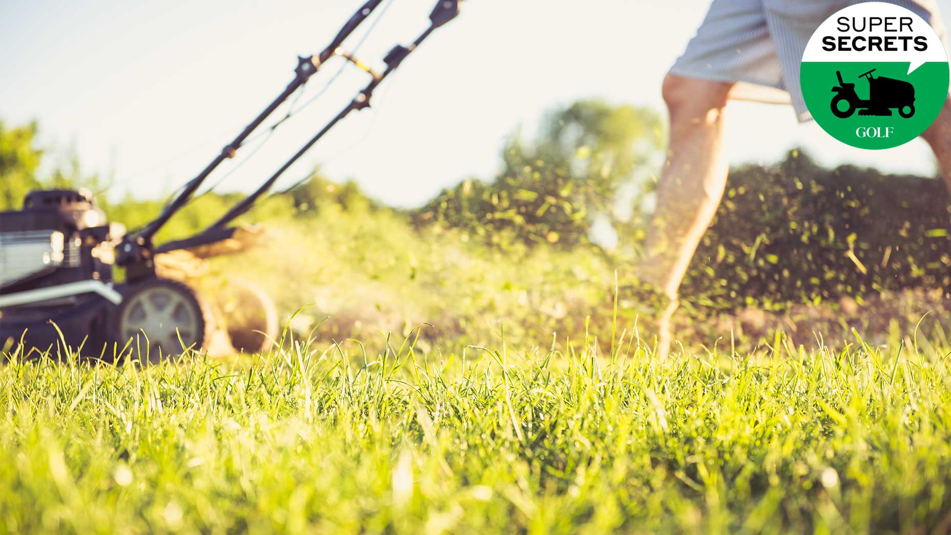 A guy mows the lawn.