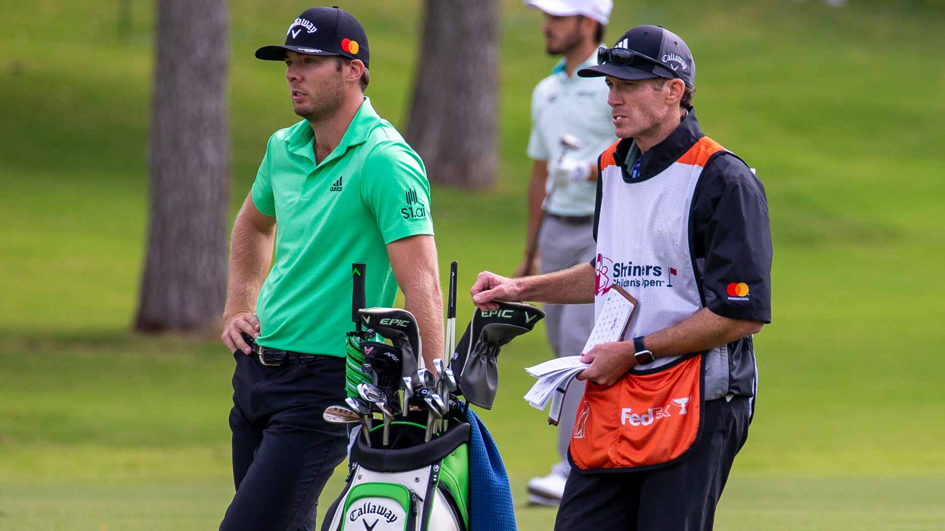 Sam Burns waits in fairway with caddie and golf bag at 2021 Shriners Children's Open