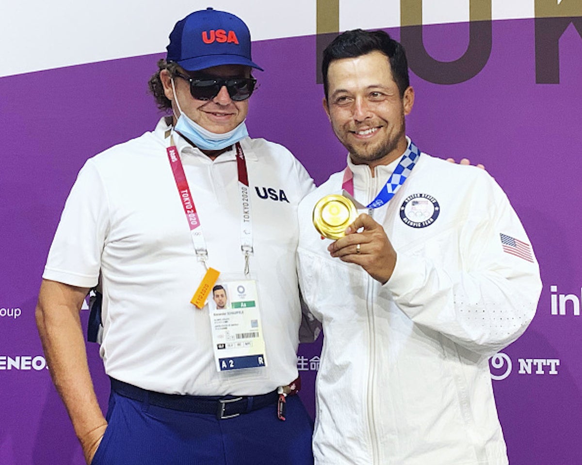 Xander Schauffele (R) of the United States poses for a photo with his father and swing coach Stefan Schauffele after winning the Tokyo Olympic men's golf tournament on Aug. 1, 2021, at Kasumigaseki Country Club in Kawagoe, Saitama Prefecture, near Tokyo. (Photo by Kyodo News via Getty Images)