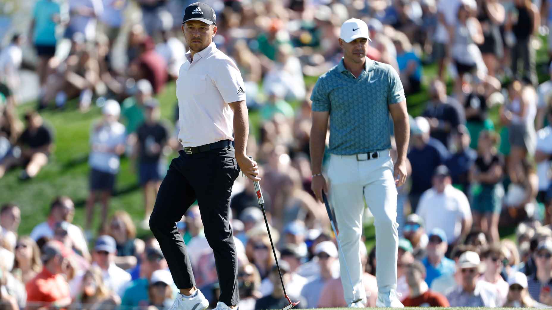xander schauffele and brooks koepka stand