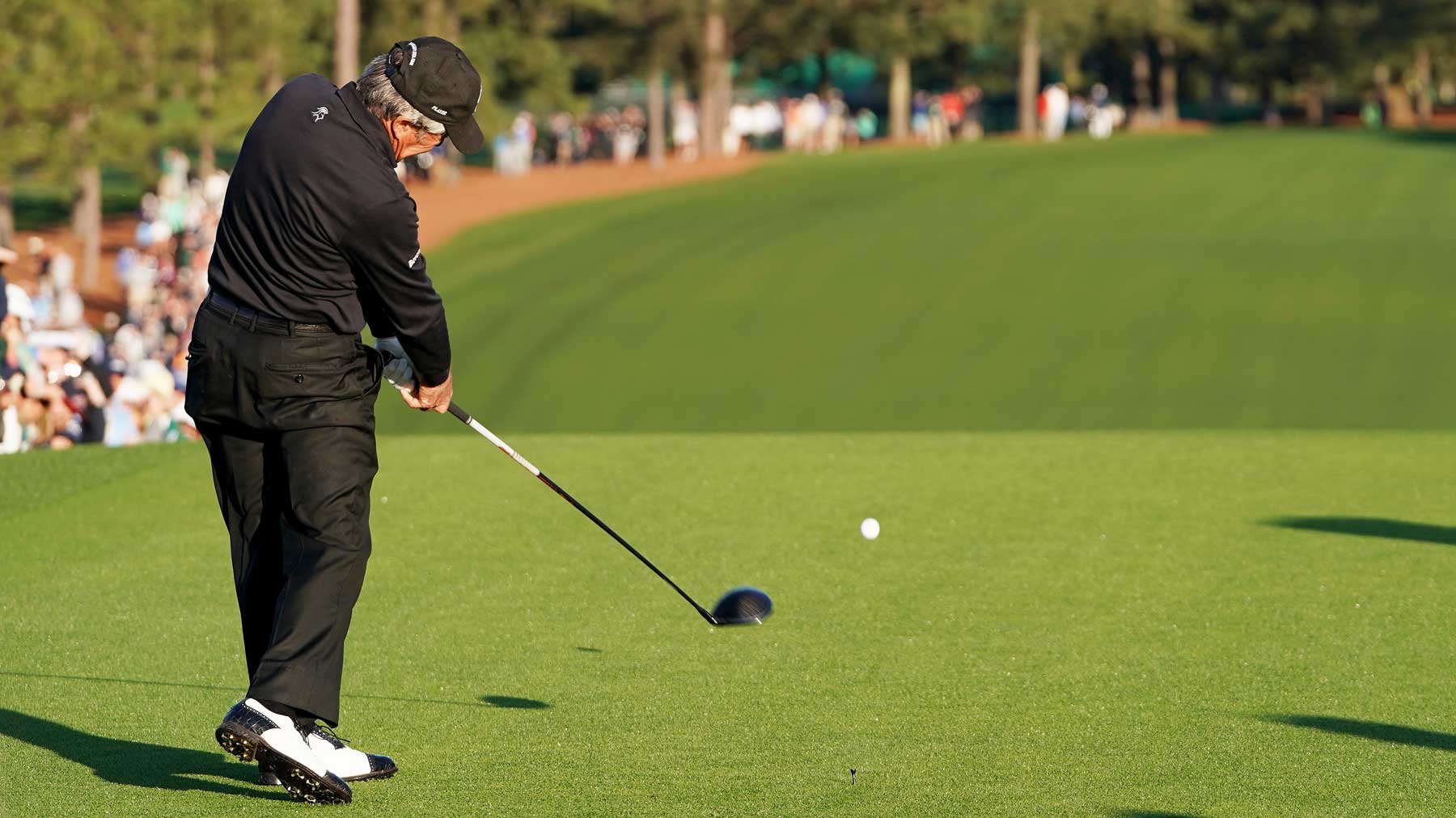 Honorary starter and Masters champion Gary Player of South Africa plays his opening tee shot on the first tee as honorary starter Lee Elder of the United States and honorary starter and Masters champion Jack Nicklaus look on during the opening ceremony prior to the start of the first round of the Masters at Augusta National Golf Club on April 08, 2021 in Augusta, Georgia