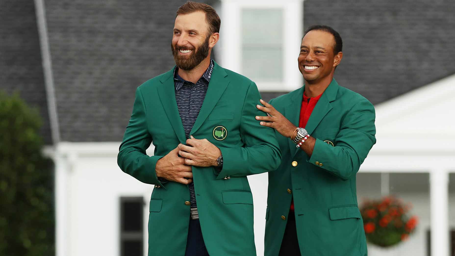tiger woods puts green jacket on dustin johnson
