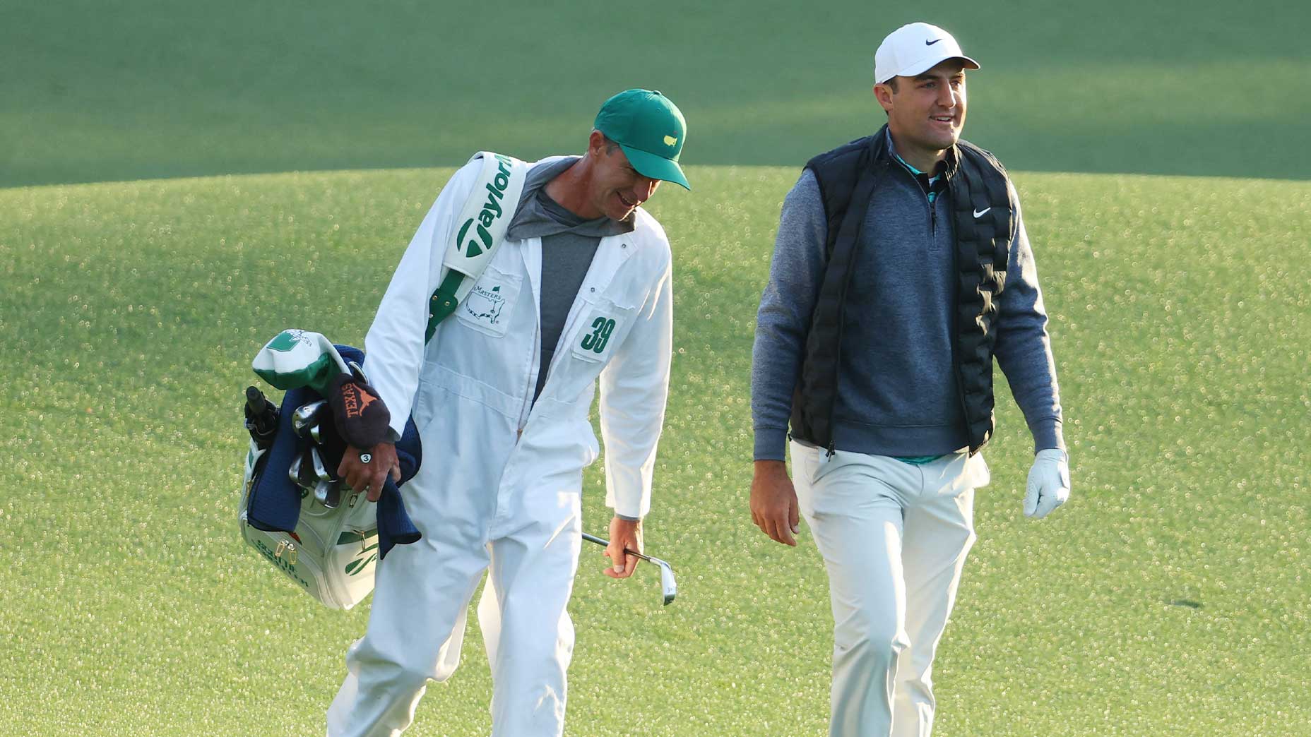 scottie scheffler walks with caddie