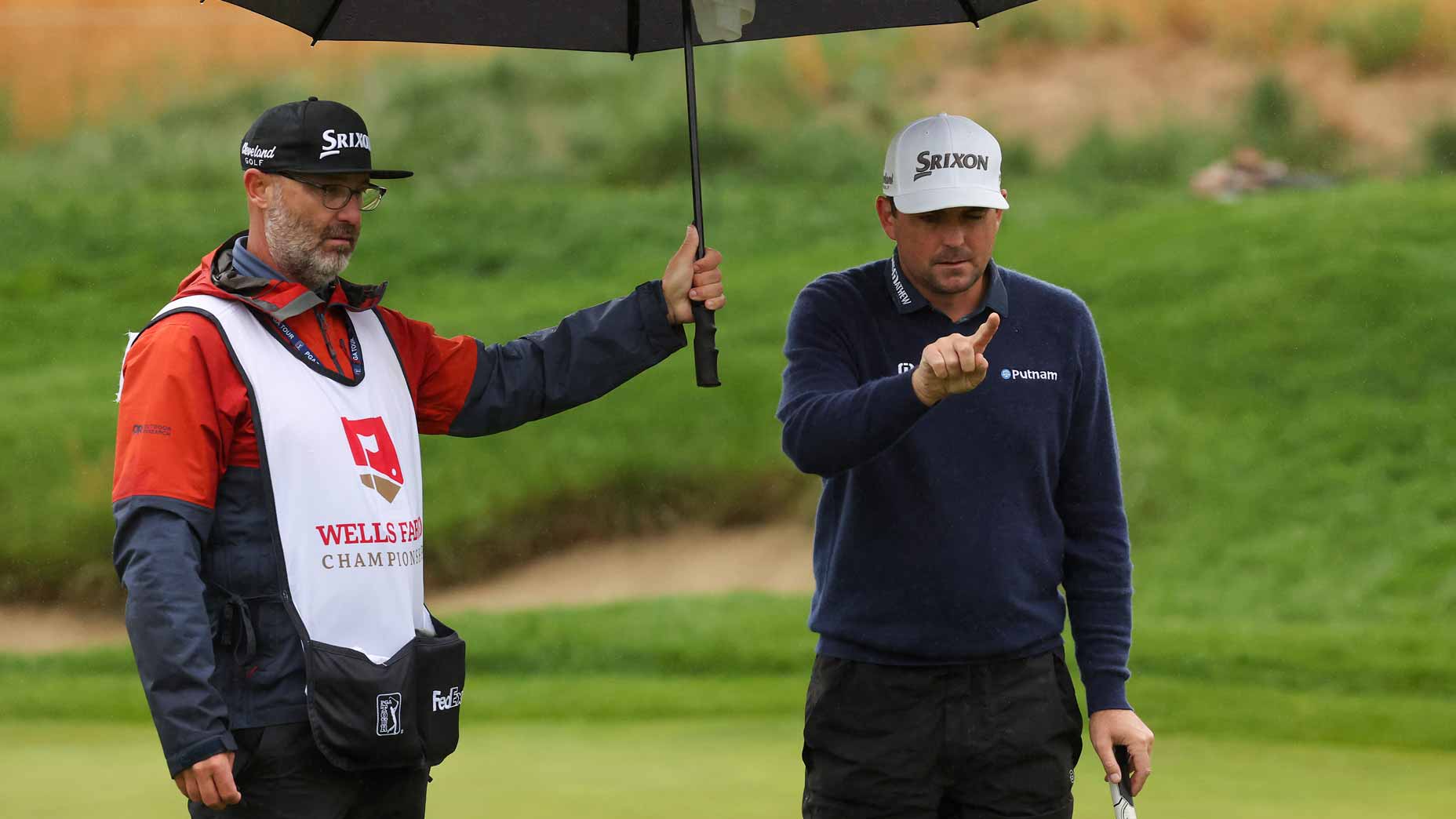 Keegan Bradley and caddie line up putt at 2022 Wells Fargo Championship