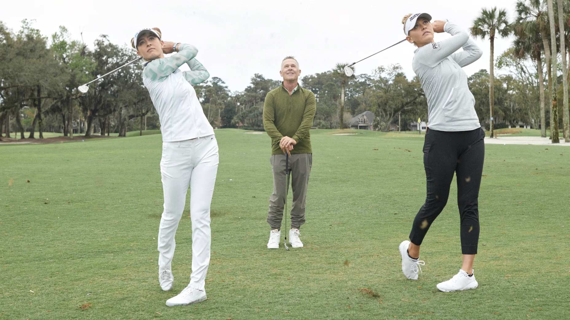 Jessica and Nelly Korda make golf swings with their coach