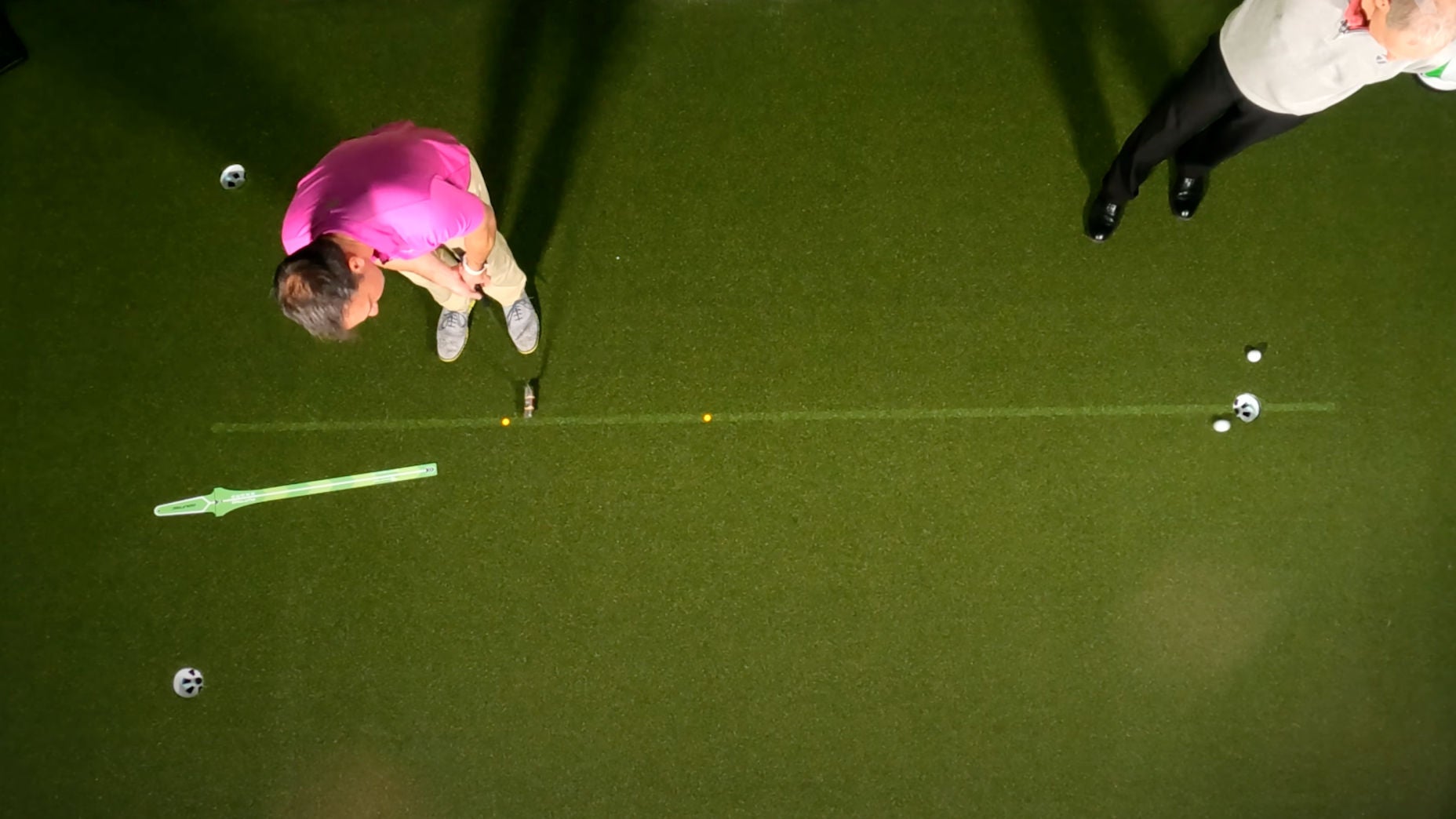 Golfer practices putting on green