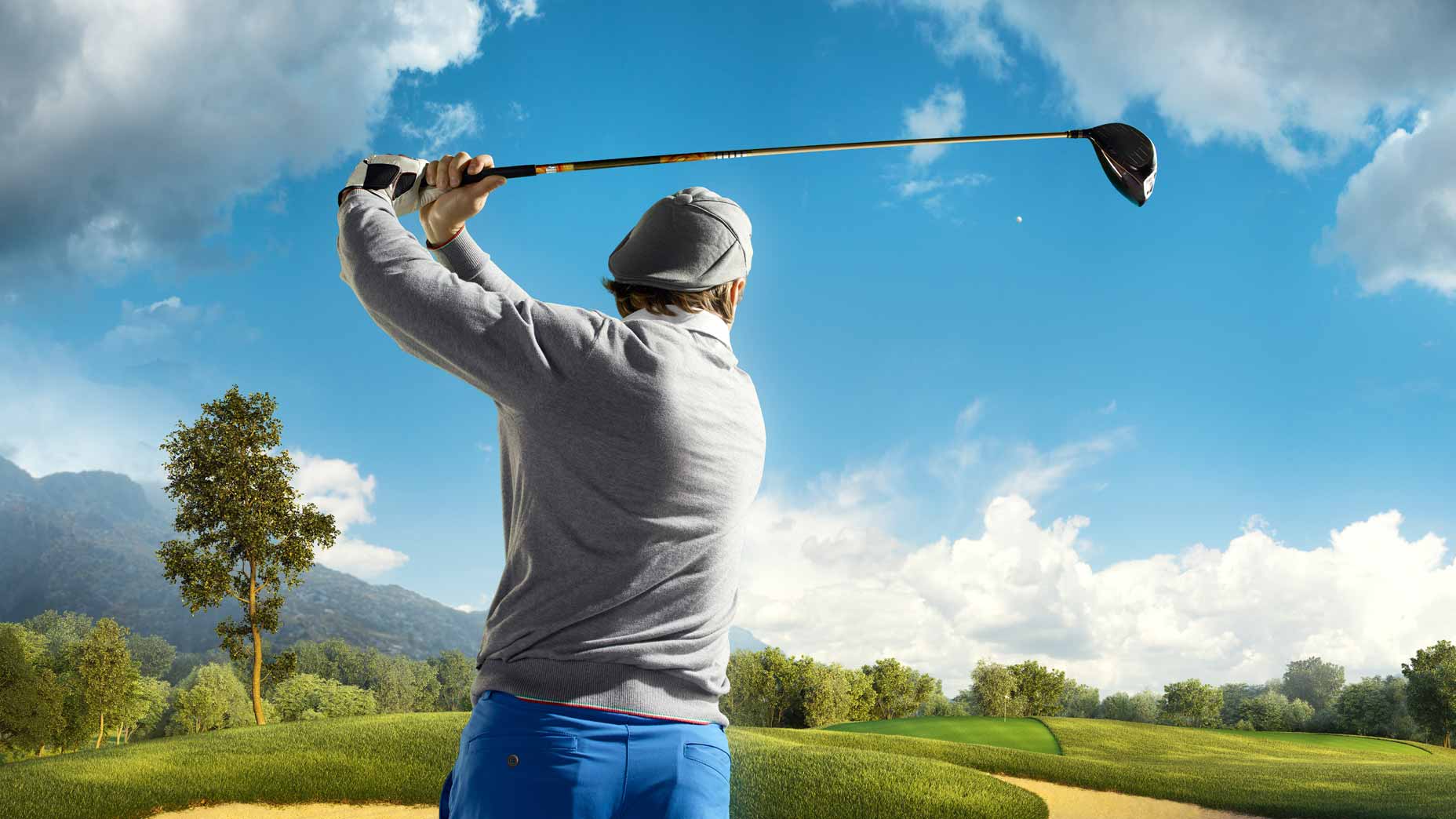 Golfer hits drive on sunny day