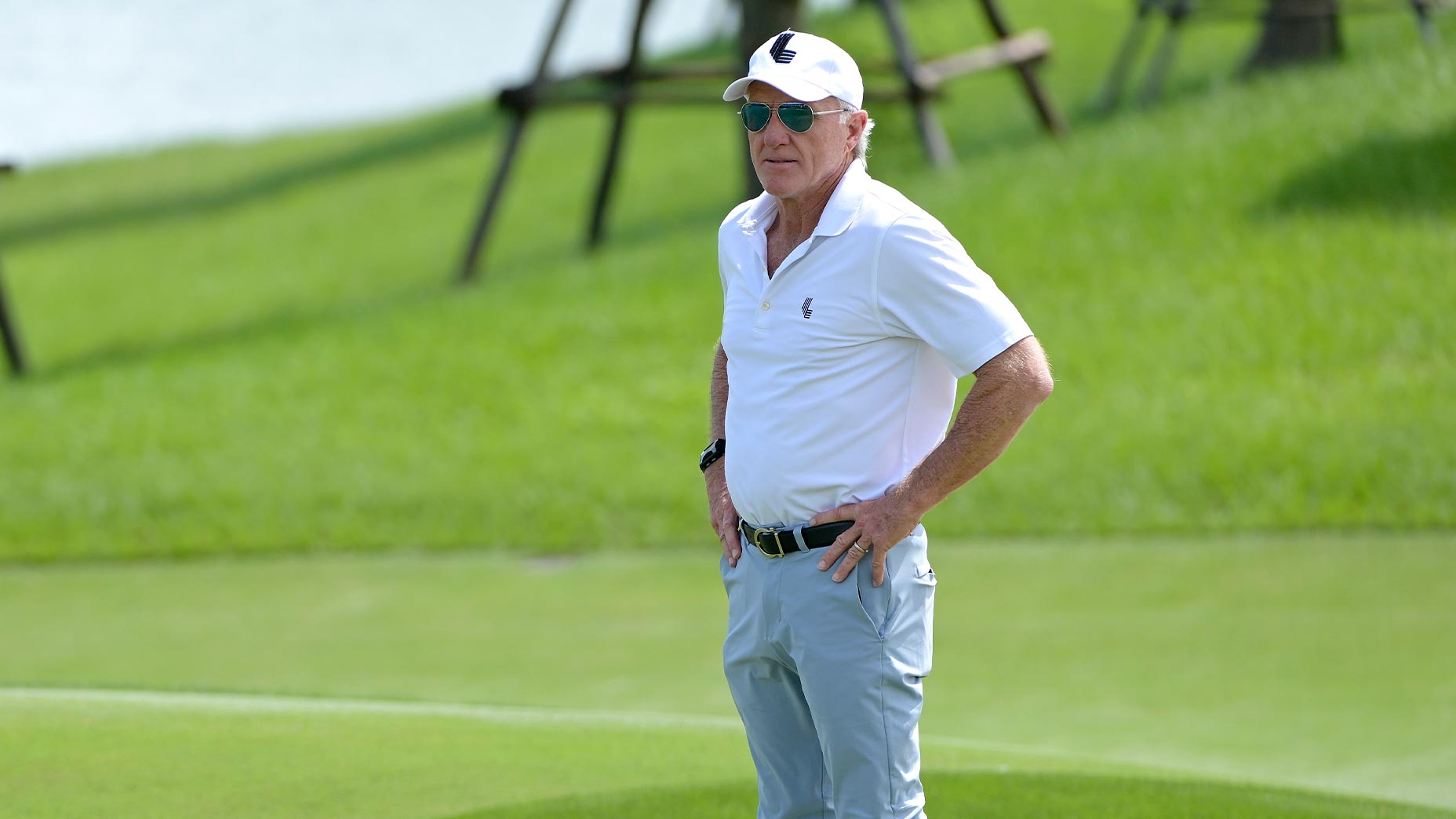 greg norman stands at tournament