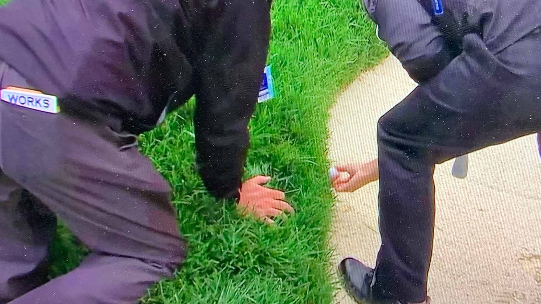 Mike Raby, a PGA of America rules official, and Corey Conners locate the golf ball.