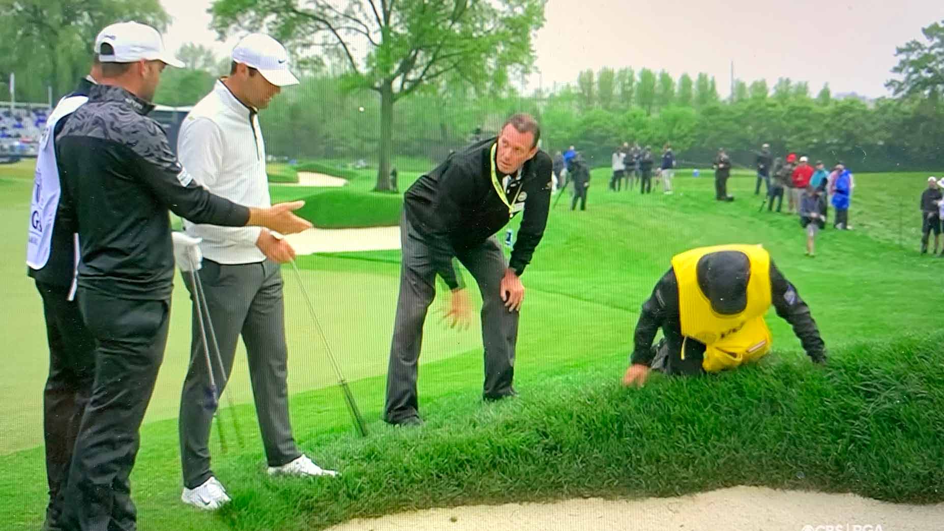 Players and a rules official talk through Corey Conners' situation on the 16th hole on Saturday at the PGA Championship.