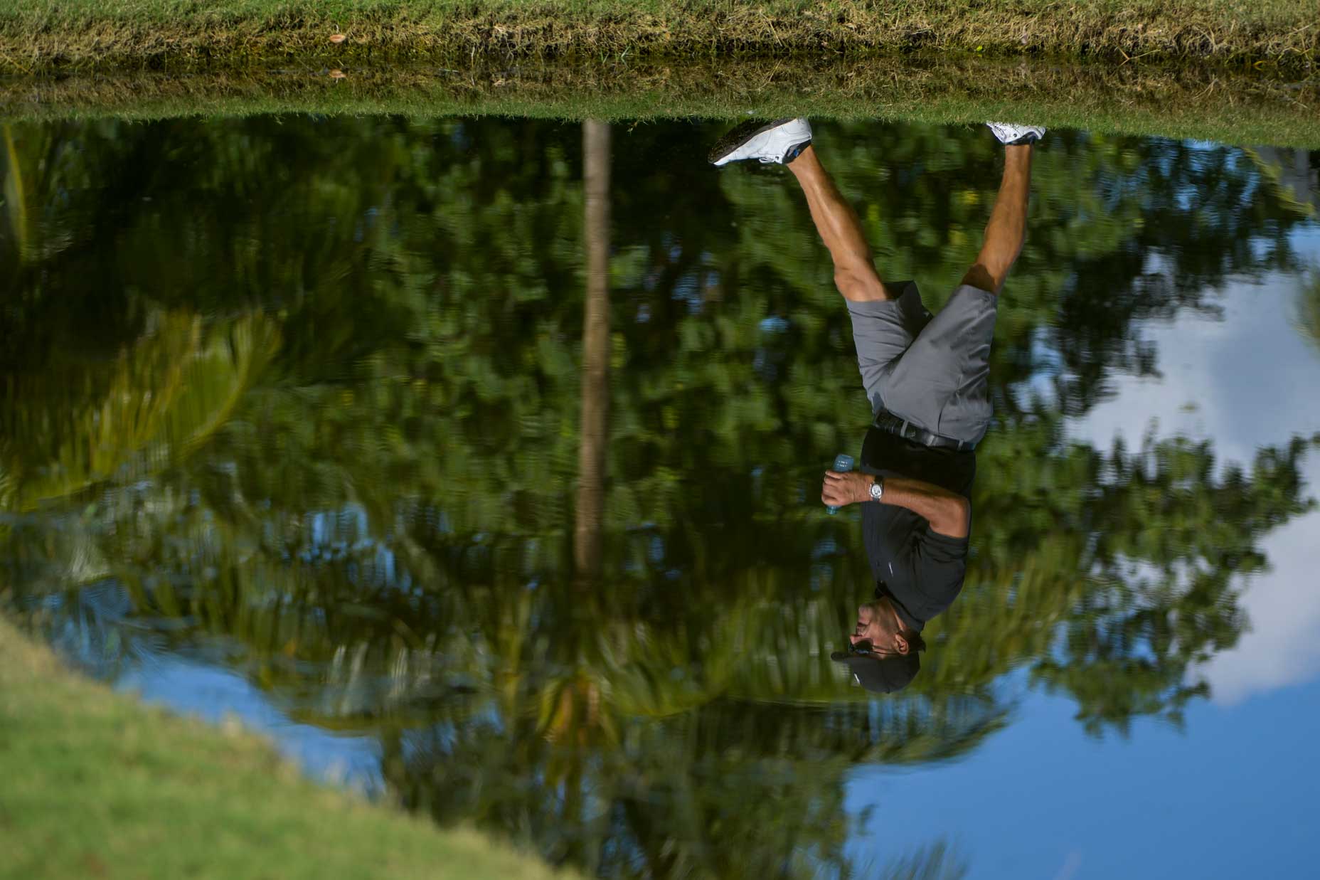 A reflection of Team Captain Phil Mickelson of Hy Flyers GC is seen as he walks the 11th hole during a pro-am prior to the LIV Golf Invitational - Miami at Trump National Doral Miami on October 27, 2022 in Doral, Florida.