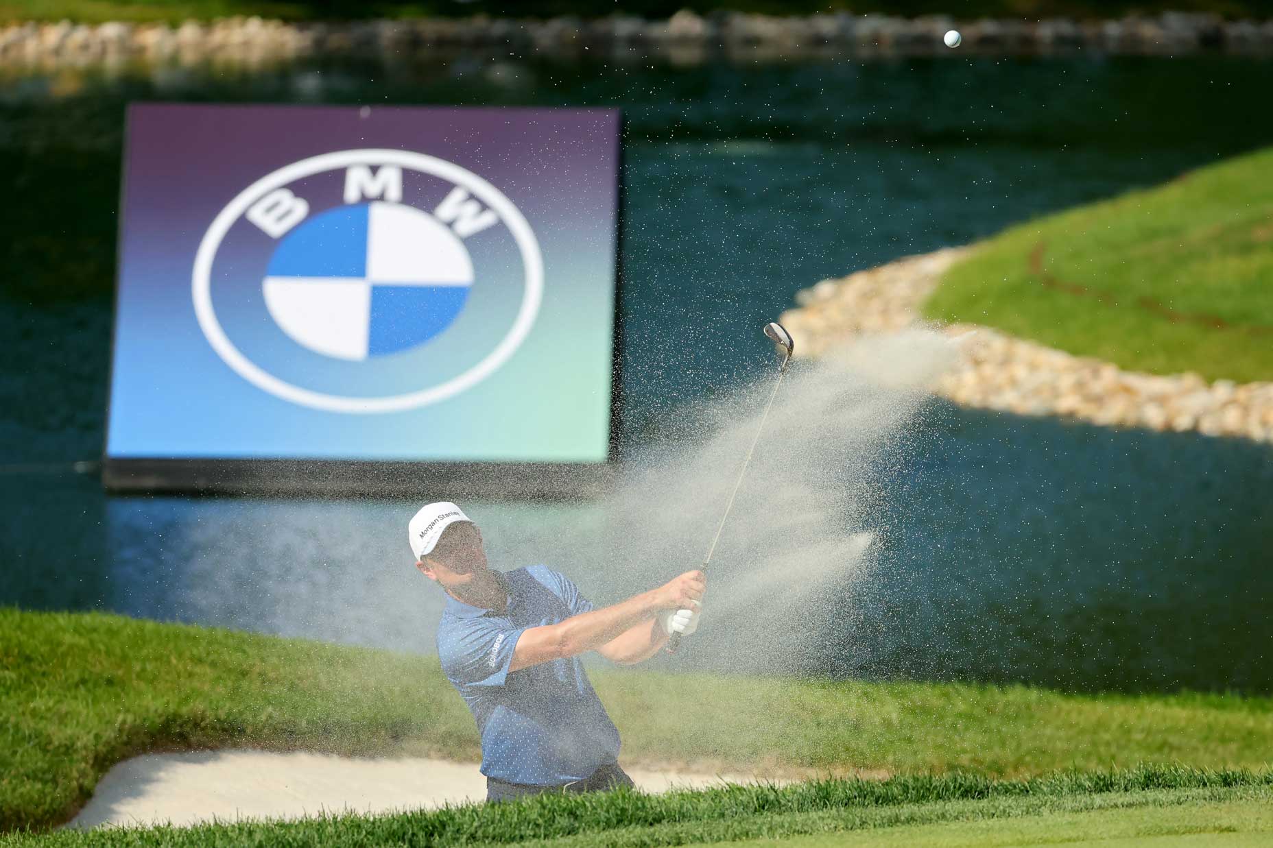 Justin Rose of England plays a shot from the bunker on the 18th hole during the third round of the BMW Championship at Olympia Fields Country Club on August 19, 2023 in Olympia Fields, Illinois.