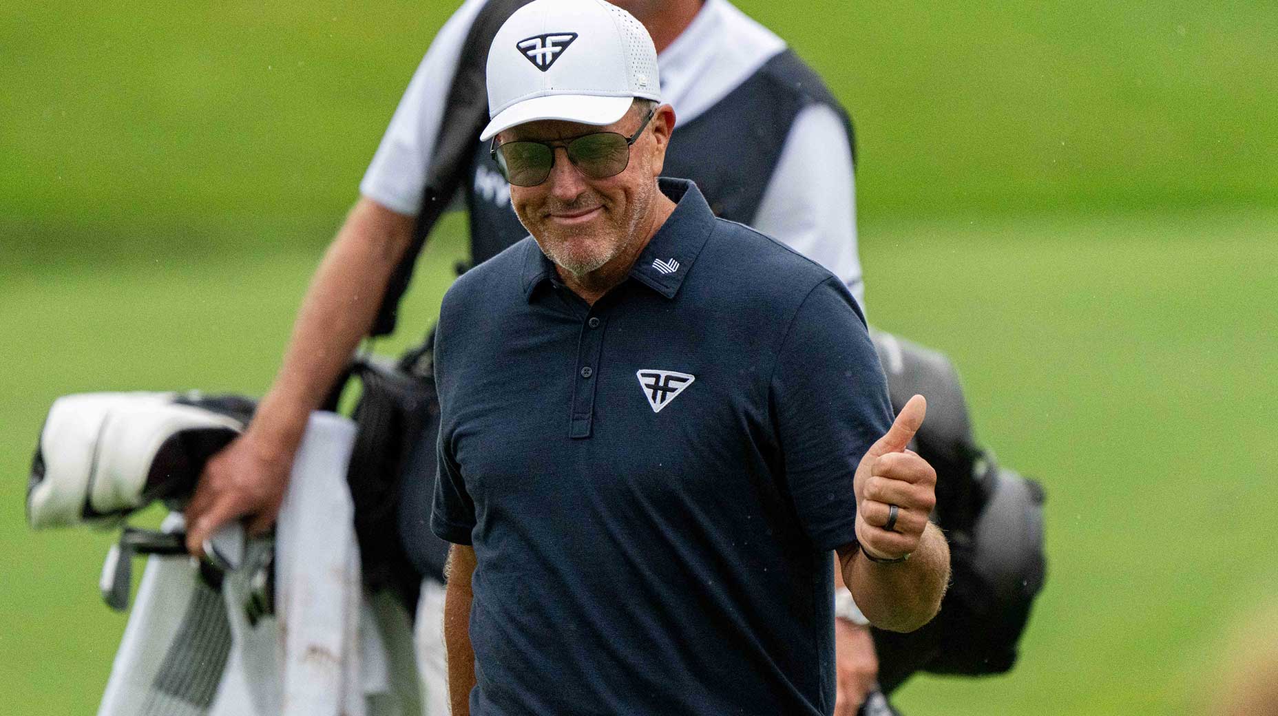 phil mickelson gives a thumbs up to fans