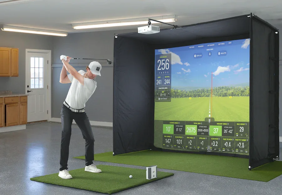 Golf simulator set-up with 3 sided enclosure, practice mat, projector and screen.