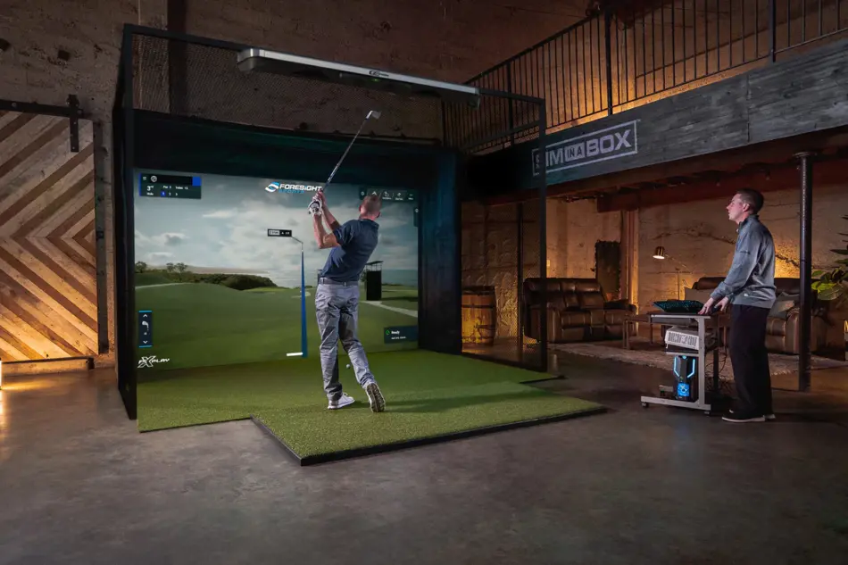 Golf simulator set-up with 3 sided enclosure, practice mat, projector and screen.