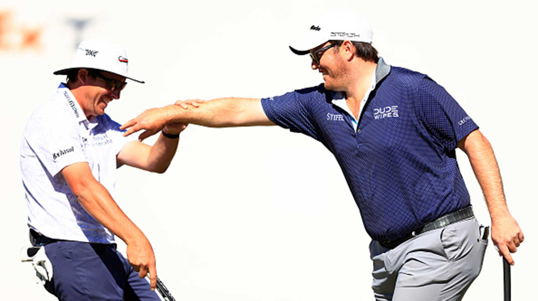 harry higgs and joel dahmen react on the green