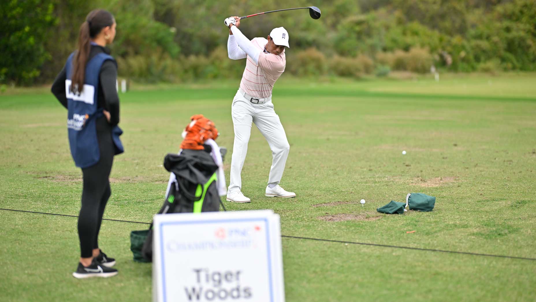 Tiger Woods warms up before the first round of the PNC Championship.