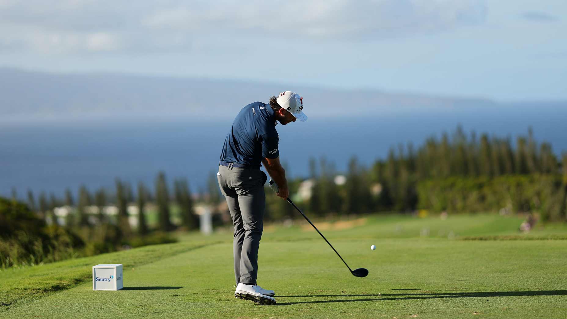 Max Homa hits a drive at Kapalua.