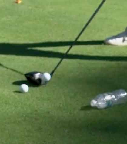 driver on the ground next to water bottle