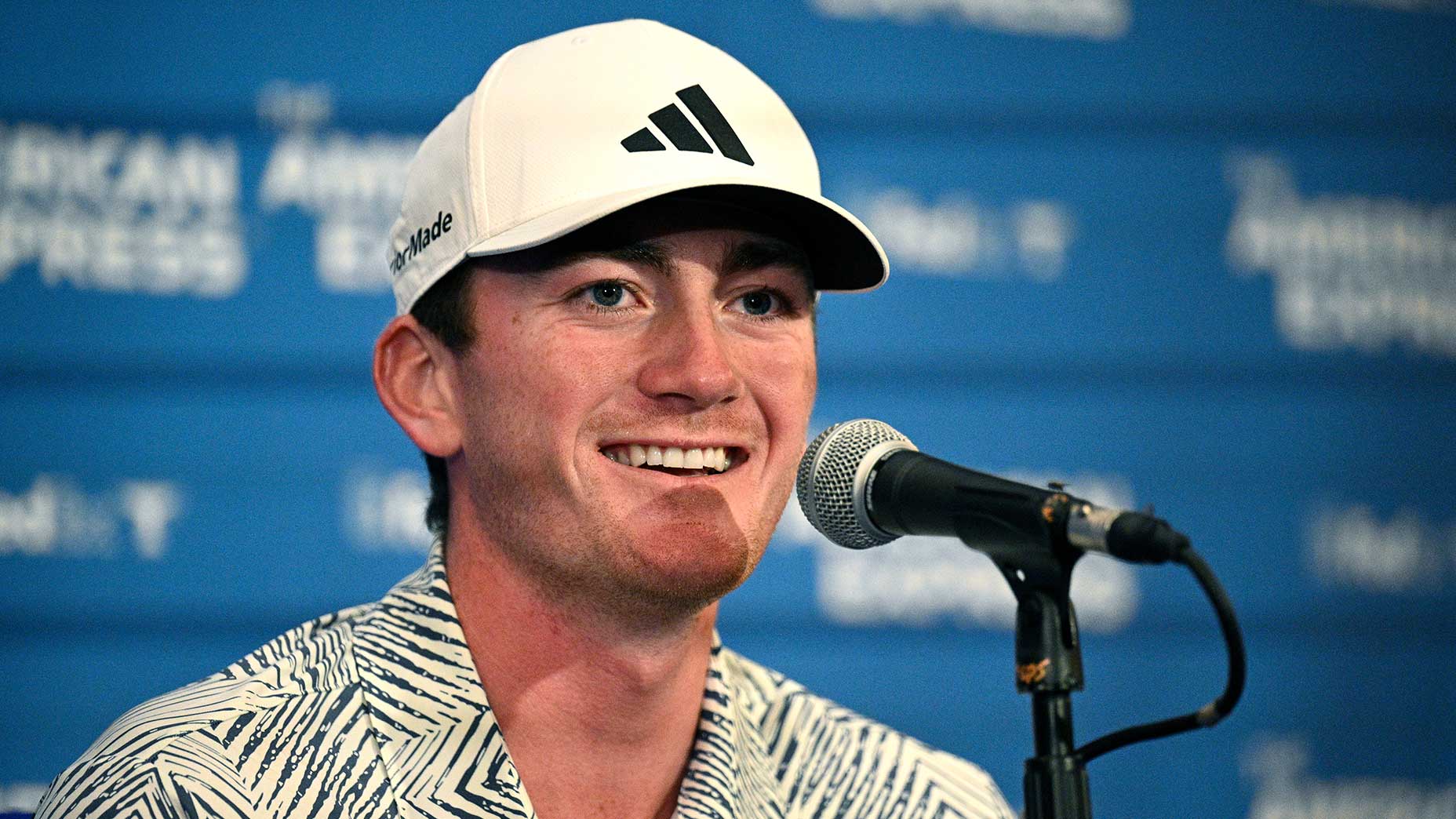 nick dunlap smiles at press conference at the american express