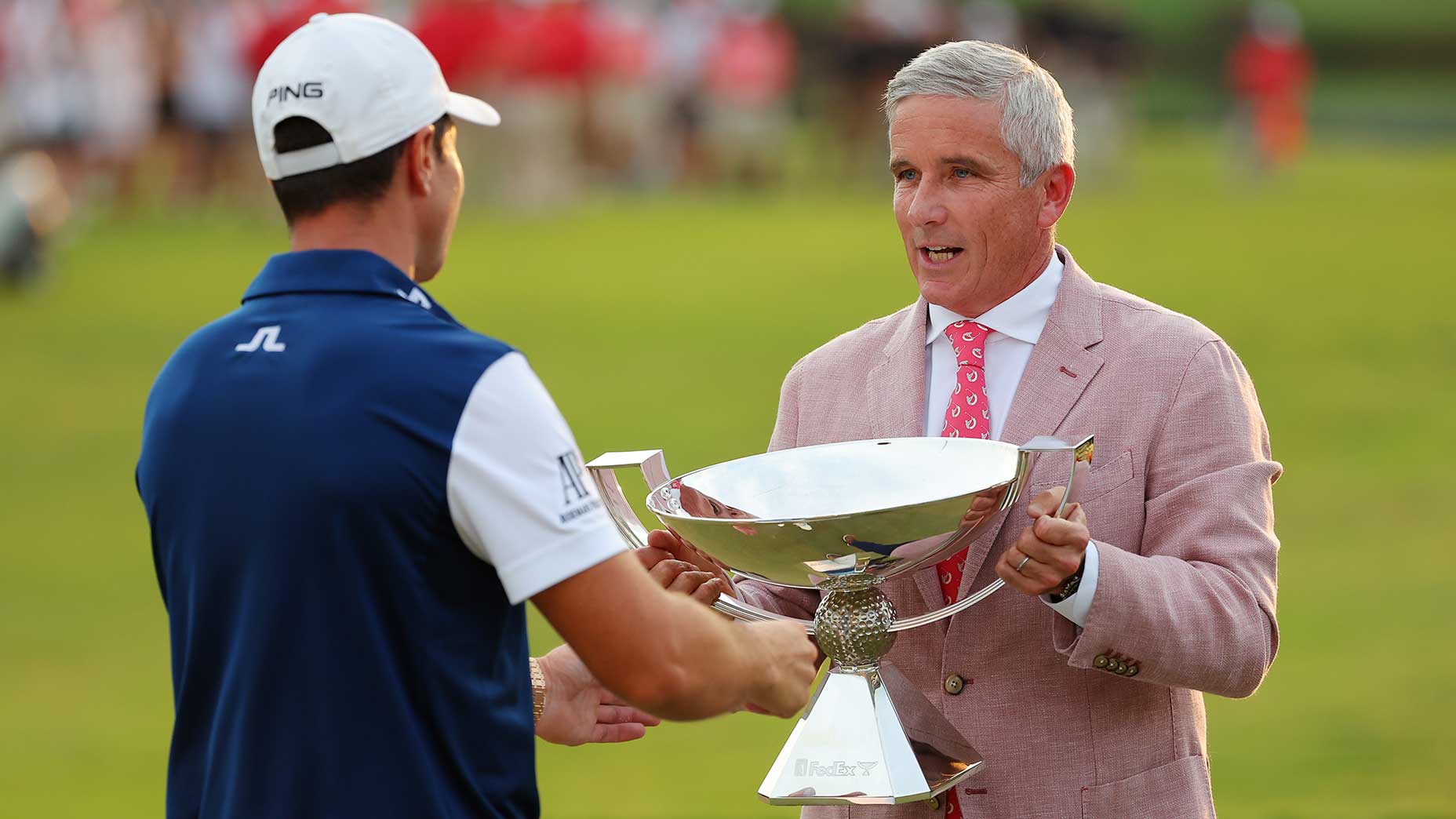 jay monahan hands pga tour championship trophy to viktor hovland