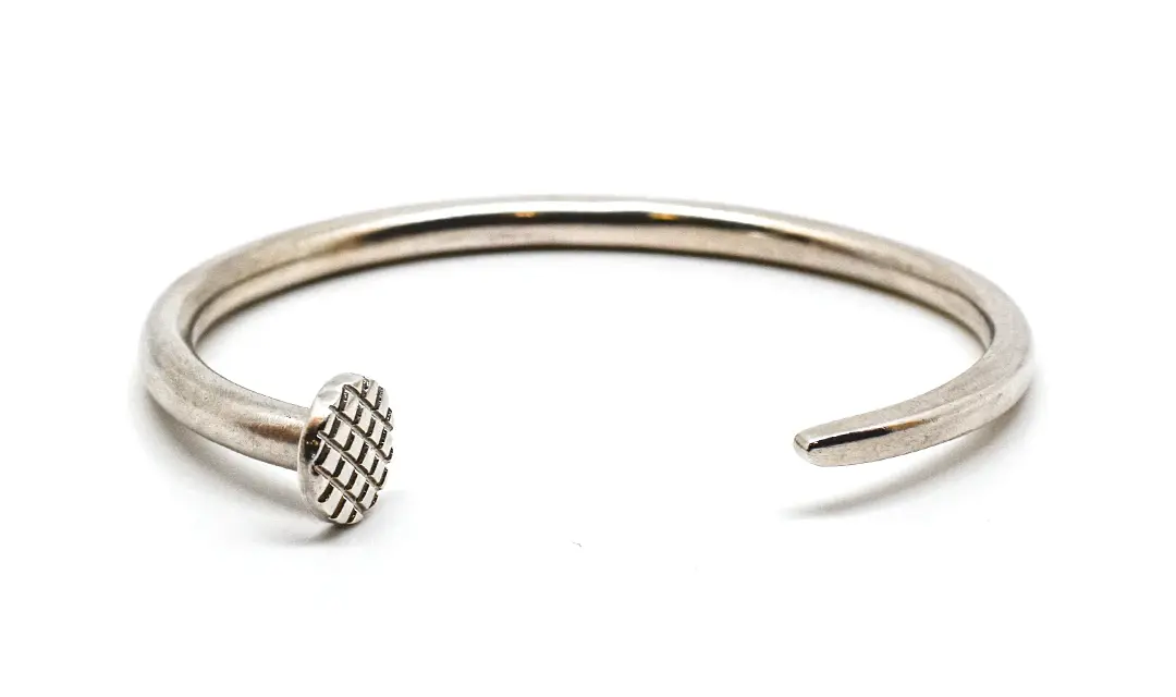 The Omega Cuff for the individual whose passion for authenticity and excellence shines through. The men's Craftsman bracelet is available in Sterling Silver and Gold precious metal finishes, and is crafted in the form of a nail &mdash;customizable to be a fit as the finishing touch on your personal style.