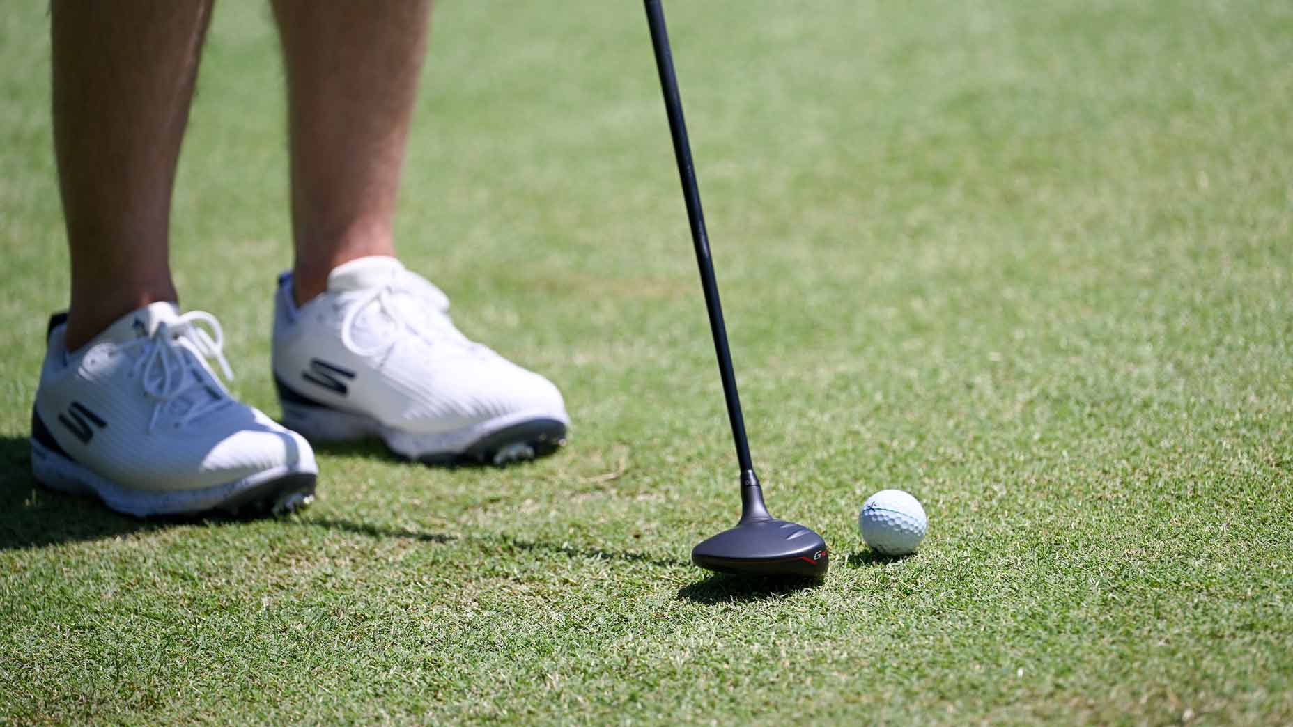 matthew fitzpatrick sets up to hit chip shot with a fairway wood