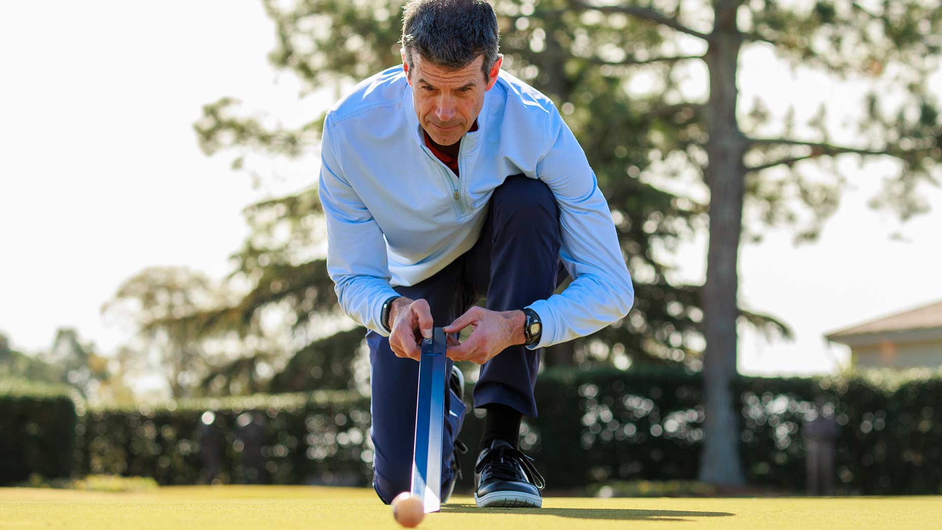 A USGA Green Sections member uses a stimpmeter.