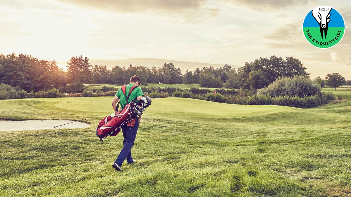 A golfer walking briskly on the course