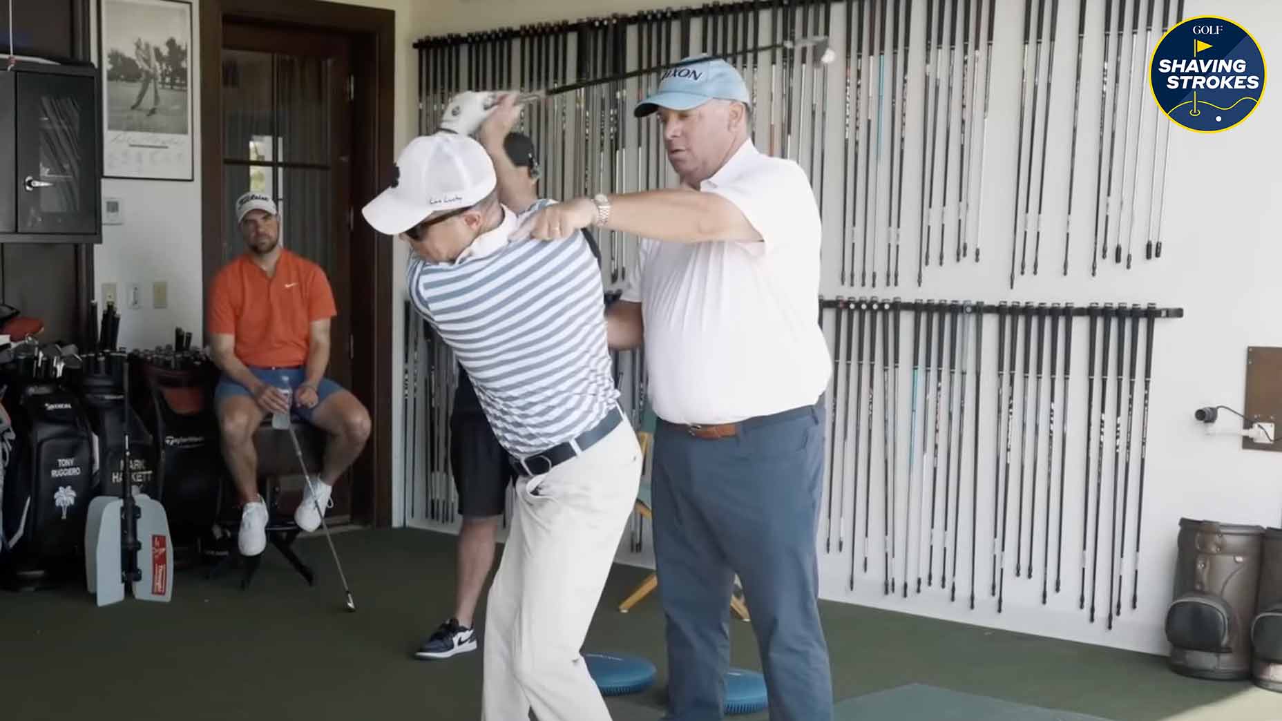 Golf Instructor helps student with swing tip